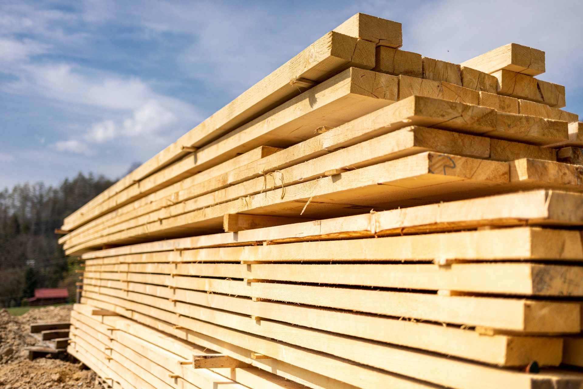 Stack of wooden beams on construction site prepared for building a house
